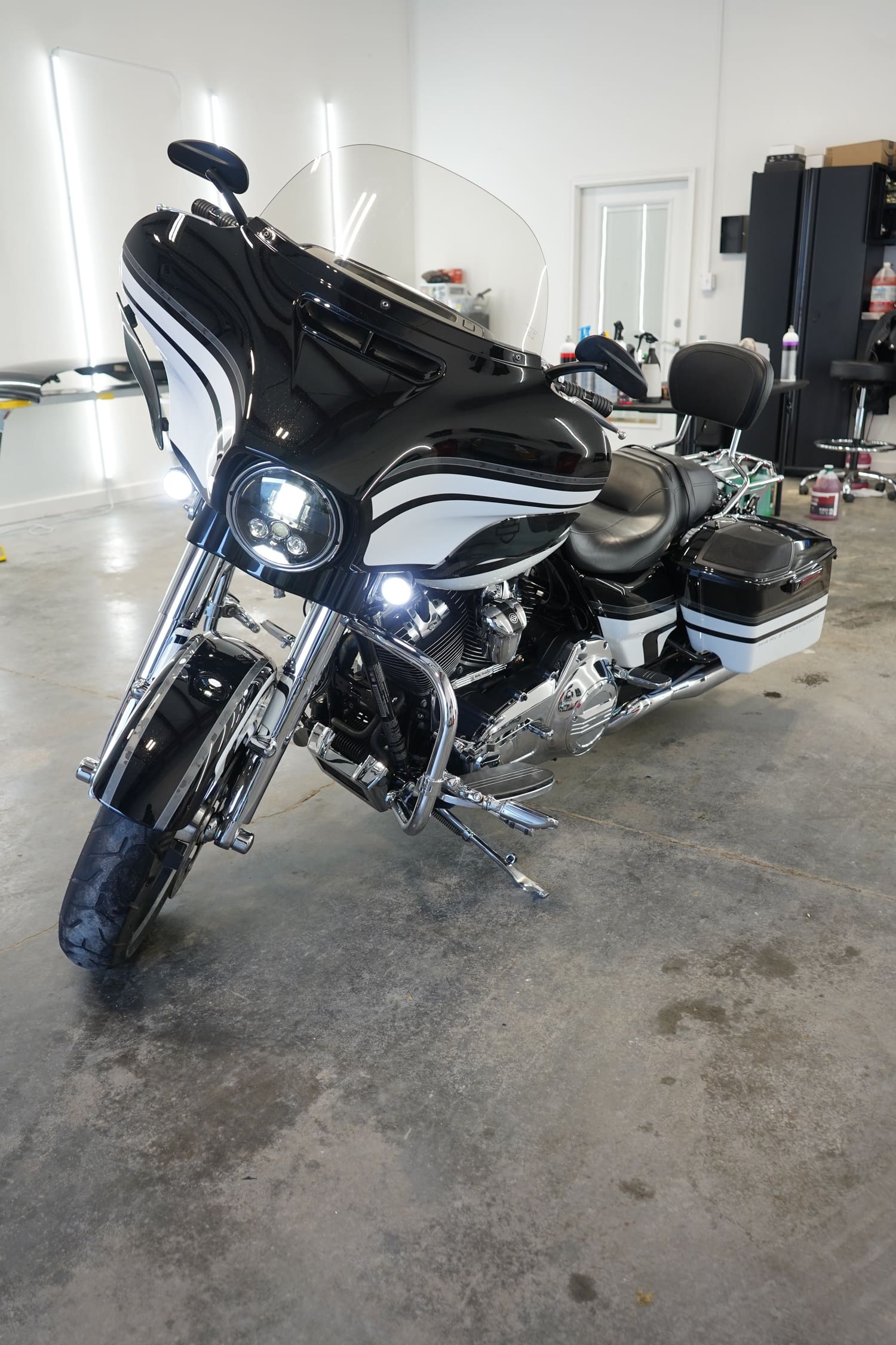 Black and white touring motorcycle with a windshield, leather seat and saddlebags
