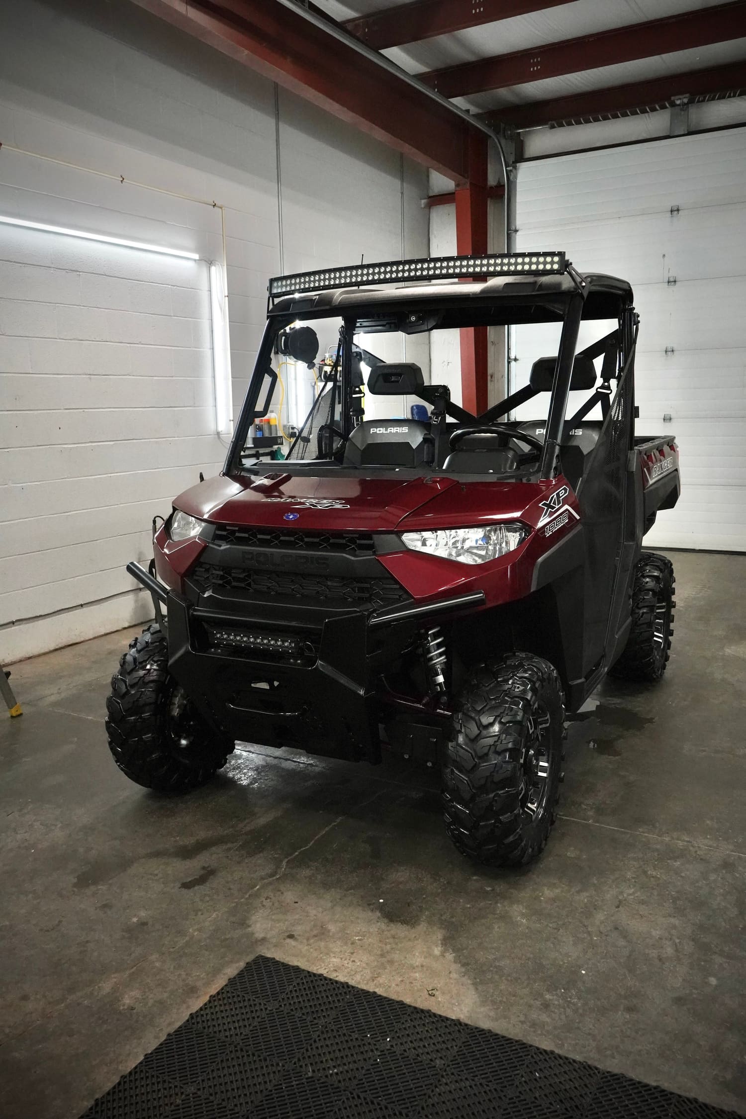 Maroon Polaris Ranger utility vehicle in the C4 bay