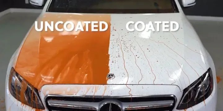 Car hood divided into two halves, one uncoated and the other coated, showing difference in paint condition with orange paint on uncoated side and streaks or coating on the other side.