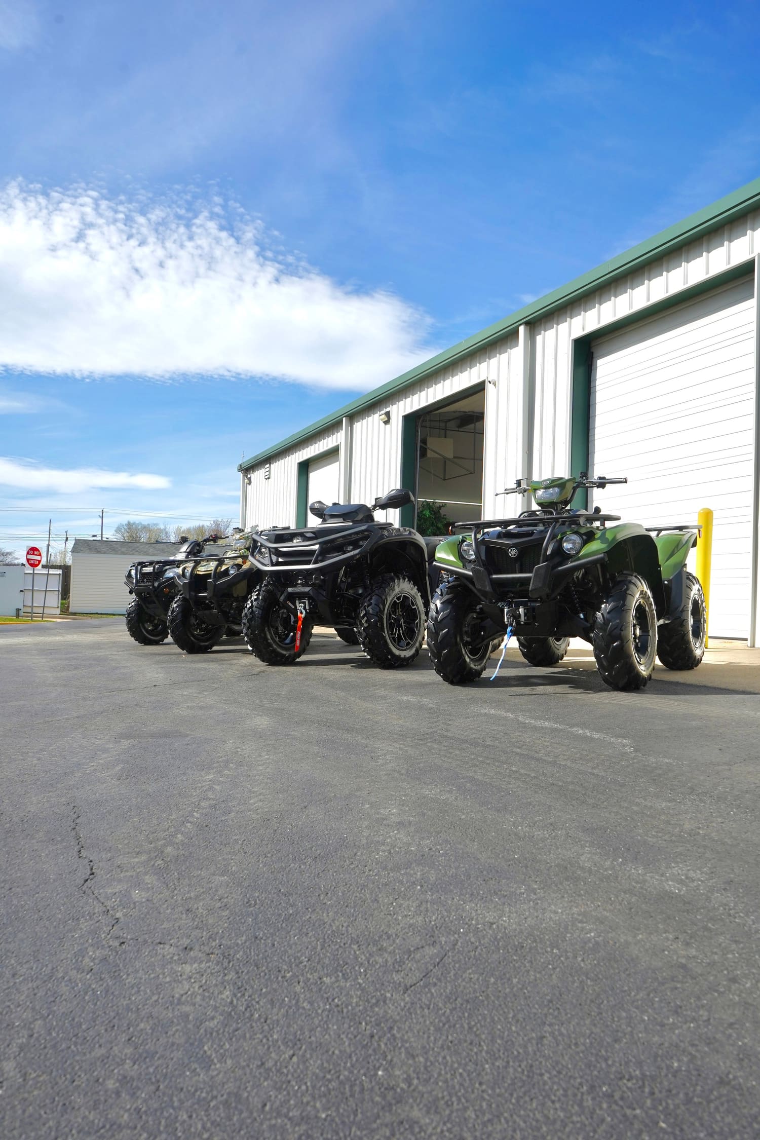 Three ATVs parked outside the C4 shop